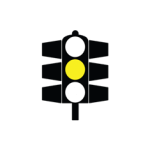 Pakistani traffic signal showing only the amber light lit, meaning stop before the stop line