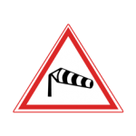 Pakistani cautionary road sign showing a windsock indicating strong cross wind inside a red-bordered triangle