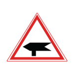 Pakistani cautionary road sign showing a roadside direction fingerpost inside a red-bordered triangle
