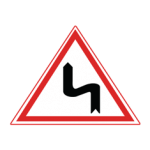 Pakistani cautionary road sign showing a double bend with the first curve to the left inside a red-bordered triangle