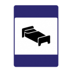 Pakistani informative road sign showing a bed symbol indicating hotel or lodging accommodation