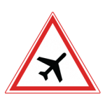 Pakistani cautionary road sign showing a low-flying aeroplane inside a red-bordered triangle
