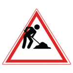 Pakistani cautionary road sign showing a worker digging with a shovel inside a red-bordered triangle