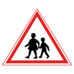 Pakistani cautionary road sign showing two school children walking inside a red-bordered triangle