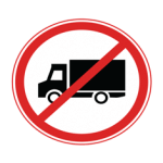 Pakistani road sign showing a black truck crossed by a red diagonal line inside a red circle, prohibiting trucks