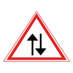 Pakistani cautionary road sign showing two vertical arrows pointing in opposite directions inside a red-bordered triangle